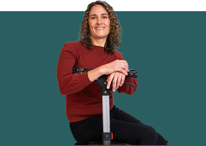 Portrait of a woman with Friedreich ataxia sitting.