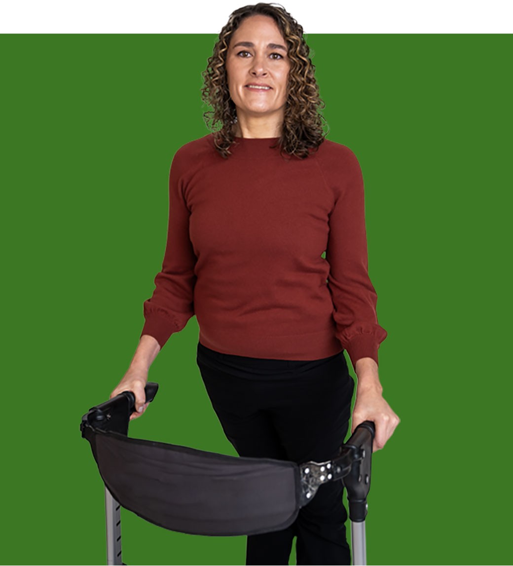 A confident woman with Friedreich ataxia standing with her assistive mobility equipment. 